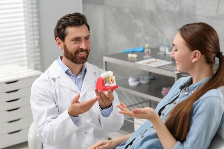 Dentist consulting a smiling patient in a modern dental clinic