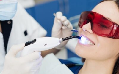 Dentist performing laser dentistry treatment for painless dental procedure
