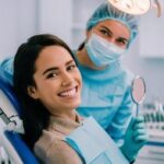 Dentist checking child and parent after vacation dental visit