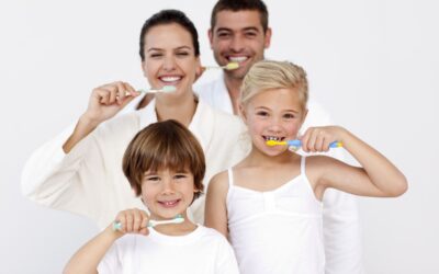 Happy family brushing teeth and maintaining oral hygiene during summer